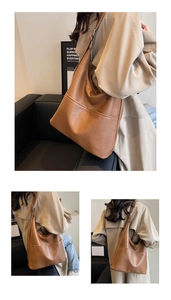 Brown faux leather shoulder bag shown on model with adjustable strap and stitch detail