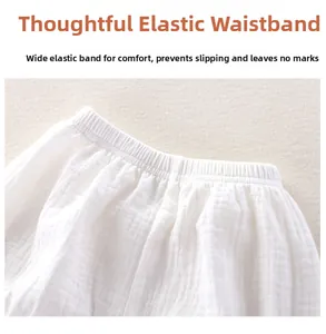 Detail of high-elastic wide waistband on breathable white cotton muslin baby trousers