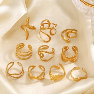 Set of 10 irregular geometric 18k gold plated stainless steel rings on beige silk