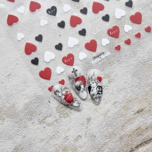 Embossed heart nail art stickers with angel and cross motifs in red, black, and white