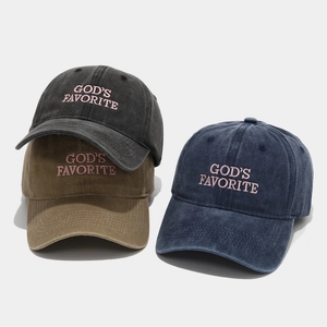 Close-up of God's Favorite embroidery on washed cotton baseball caps in three colors