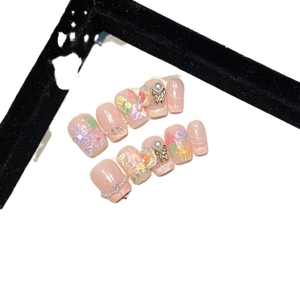 Handmade press-on nails set with floral patterns, pearls and gold butterfly charms