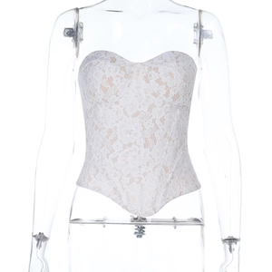 Close-up of cream lace corset top with floral embroidery and heart-shaped neckline