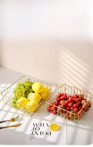 Detail of golden hollow iron fruit baskets showing breathable wire mesh texture