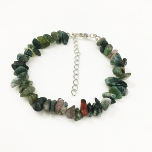 Macro view of natural green epidote and moss agate stone bracelet with adjustable silver clasp