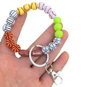 Handheld sports themed wood bead keychain featuring soccer, basketball and baseball charms