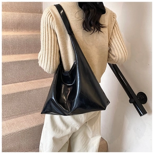 Detailed back view of a black glossy patent leather large capacity Hobo shoulder bag