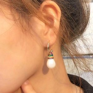 Rainbow pavé zircon ear hook with white drop pearl on female model showing elegant style