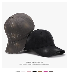 Close-up of vintage washed cotton baseball caps with distressed edges and embroidery