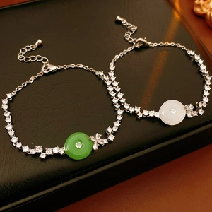 Close-up of zircon chalcedony bracelets in green and white on a black display stand