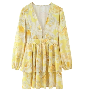 Detail of V-neckline and yellow floral print fabric on the tiered ruffled dress