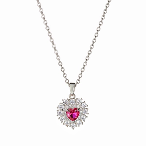 Close-up of silver necklace with heart-shaped red ruby pendant and white zircon halo