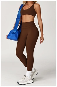 Detail of high-waisted yoga leggings and U-neck sports bra in chocolate brown
