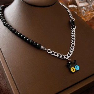 Detail of creative asymmetric chain necklace with half black beads and silver metal links