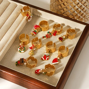 Set of 10 gold-toned stainless steel Christmas rings with festive charms and enamel