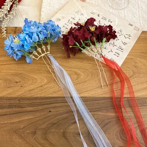 Elegant vintage fabric flower hair pins with long silk ribbons and golden metal clips
