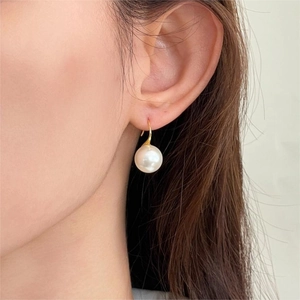 Elegant 925 sterling silver pearl hook earrings for women shown on a model
