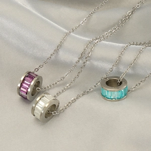 Three silver stainless steel necklaces with purple, white, and turquoise crystal rings