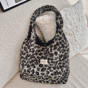 Macro detail of leopard faux fur tote bag showing secure magnetic closure and soft lining