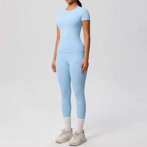 Detail of light blue yoga set featuring breathable short sleeve top and high waist leggings