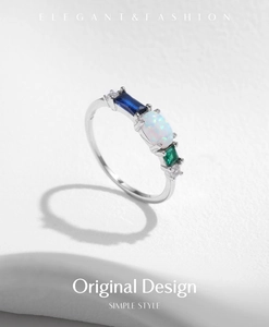 Detail of s925 silver ring featuring oval white opal and colorful rectangular gemstones