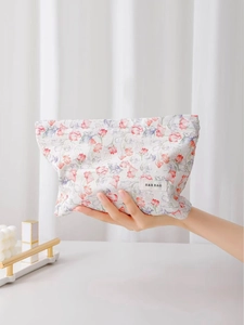 Floral cotton canvas cosmetic bag with zipper and H&R logo in a lifestyle setting