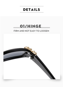Close-up of premium gold-toned metal hinge on glossy black rectangular sunglasses