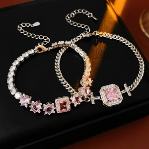 Detailed shot of silver bracelets with pink square zircon and classic lobster clasp