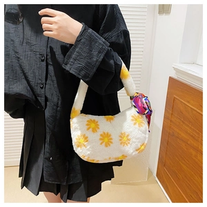 Detail of white fluffy handbag with yellow daisy patterns and a colorful silk scarf handle