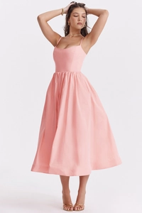 Detail of a pink backless midi dress featuring a cinched waist and pleated A-line skirt