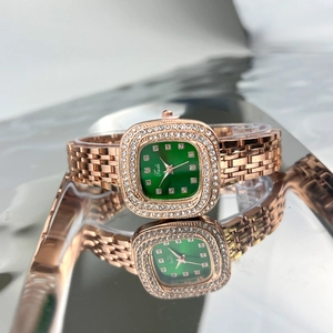 Detail of square green dial watch with rose gold strap and diamond bezel on mirror