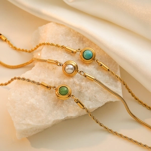 Gold-plated stainless steel bracelet set with turquoise and pearls on white silk