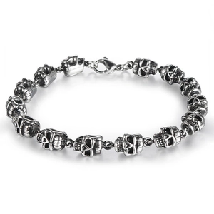 Detailed macro view of silver skull punk bracelet with polished steel finish and lobster clasp