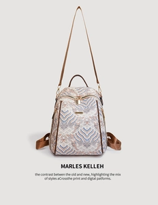 Detail of Chinese style printed backpack with blue patterns and brown straps on cream canvas