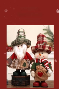 Detail of Christmas gnomes with plaid hats and scarves for festive home table decoration