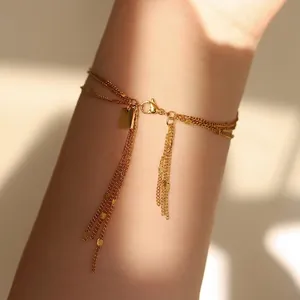 Three-layer gold tassel bracelet in 18K plated titanium steel with rectangular tag
