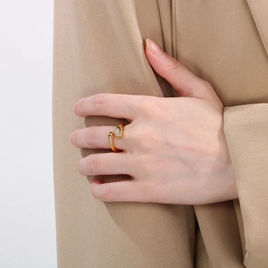 Gold snake wrap open ring in stainless steel with diamond accent on model hand