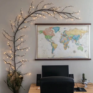 Macro view of warm white LED branch lights placed in a pot near a world map background