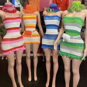 Detail of handmade crochet bikini sets with striped patterns and matching ruffled straw hats