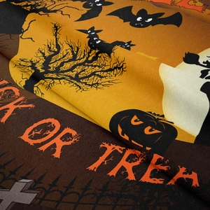 Close-up of soft flannel Halloween tapestry fabric featuring Trick or Treat festive print