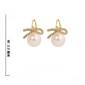 Detail view of bowknot pearl earrings showing 2.5cm height and 1.8cm width dimensions