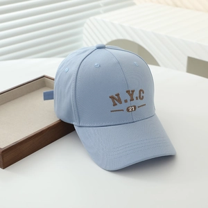 Detail of light blue cotton baseball cap featuring NYC 21 brown 3D letter embroidery