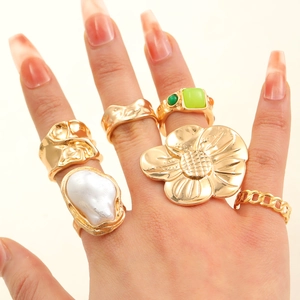 Baroque pearl and floral gold ring set featuring vintage lava metal and green gemstones
