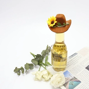 Miniature brown cowboy hat for wine bottles with sunflower detail on a clean white backdrop