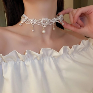 Detailed close-up of a multi-layer faux pearl flower choker on a model's neck