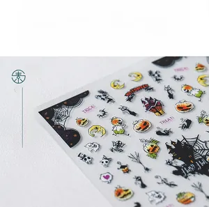 Detailed view of Halloween nail stickers featuring pumpkins, bats, and ghosts patterns
