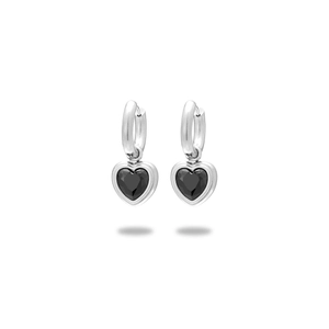 Macro view of silver stainless steel hoop earrings with black heart-shaped gemstone charms