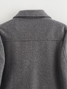 Detail of dark grey wool jacket showing back collar stitching and textured fabric
