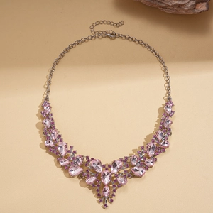 Macro detail of luxury water-drop pendant necklace with pink rhinestones and silver chain