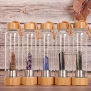 Bamboo lid glass bottles featuring natural hexagonal crystal points in a rustic setting